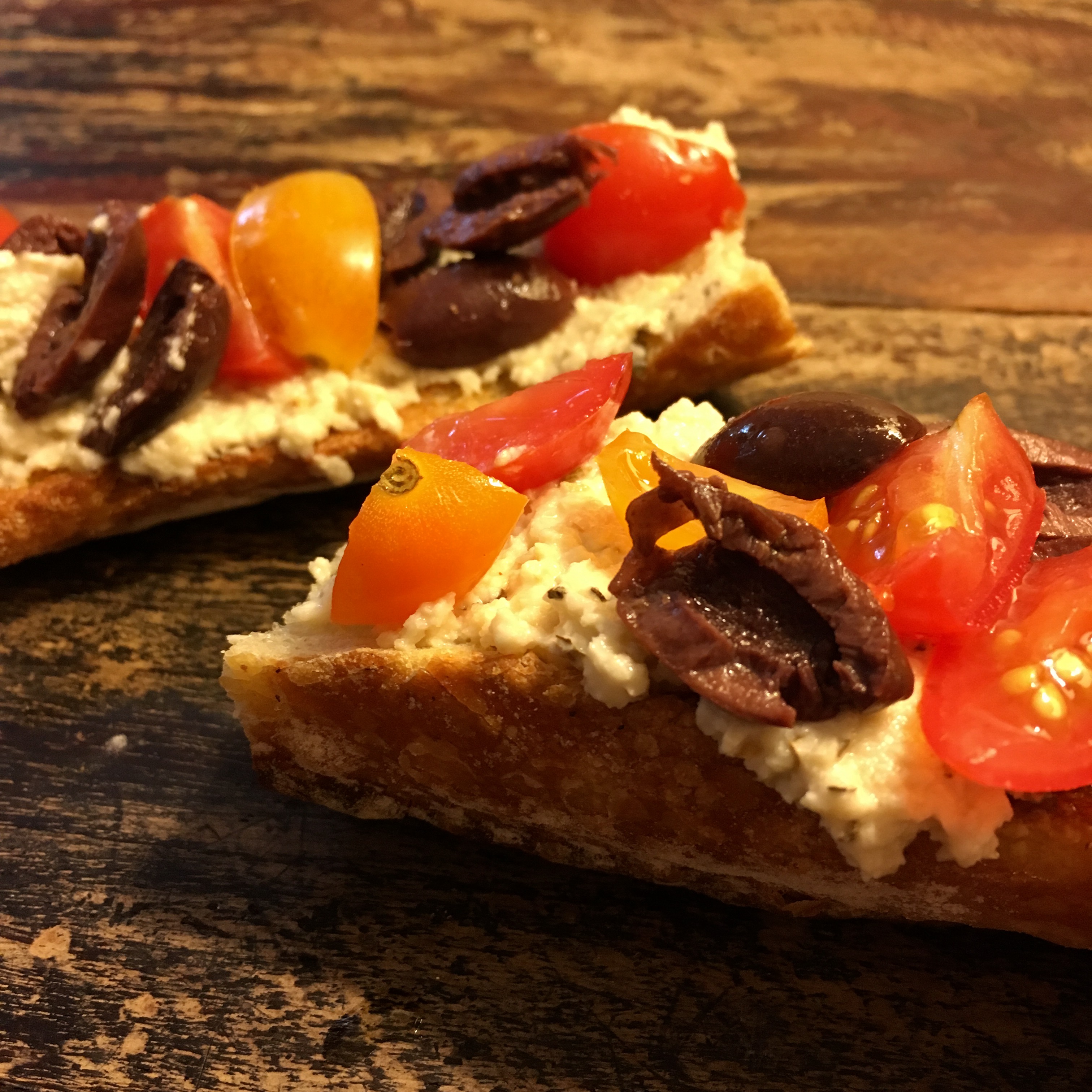 TOASTED BAGUETTE WITH HERBED CASHEW RICOTTA, OLIVES AND CHERRY TOMATOES - gluten-free option